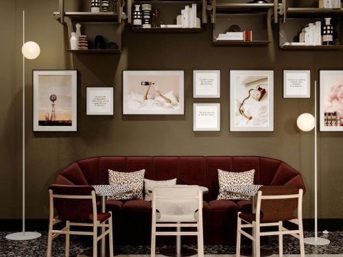 a living room with a couch and two chairs at TRIBE Strasbourg Centre Gare in Strasbourg