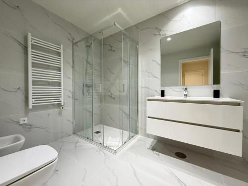 a bathroom with a shower and a toilet and a sink at Gerês River Terrace in Geres