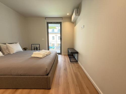 a bedroom with a large bed and a window at Gerês River Terrace in Geres