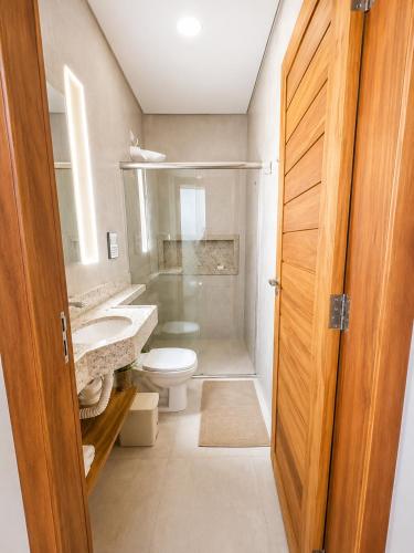 a bathroom with a toilet and a sink at Villa Rita - Preá in Prea