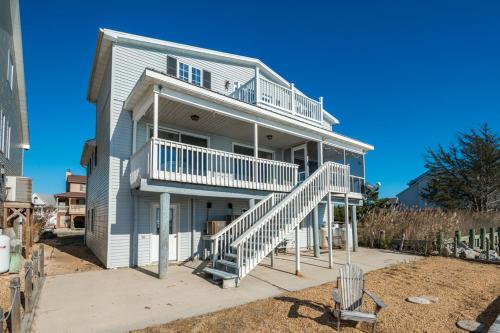 a large house with stairs on the side of it at Serenity Now in Greenbackville