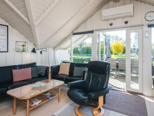 a living room with a couch and a table at 4 star holiday home in Hejls in Hejls