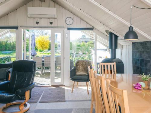 a kitchen and dining room with a table and chairs at 4 star holiday home in Hejls in Hejls