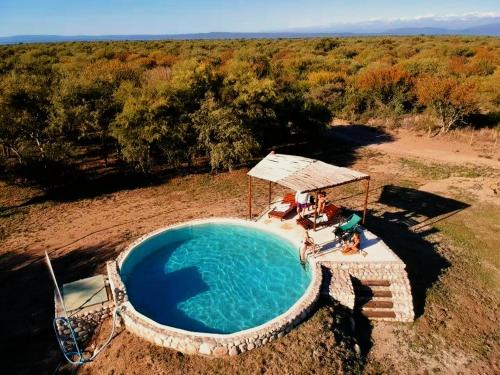 an overhead view of a swimming pool in a field at Refugio Serrano con Chimenea y Caballos in San Javier