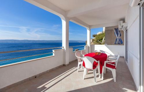 a balcony with a table and chairs and the ocean at Apartments Nena in Pisak