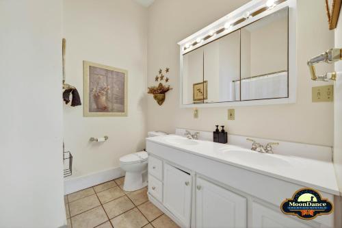 a white bathroom with a sink and a toilet at Nashville Suite 1 in Nashville