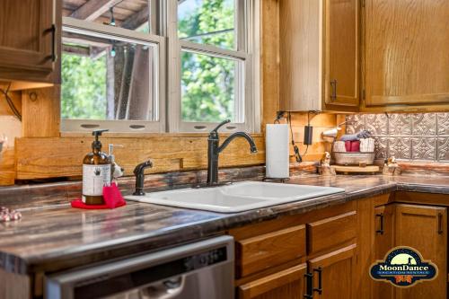 a kitchen counter with a sink and a window at Dogwood Hills in Nashville