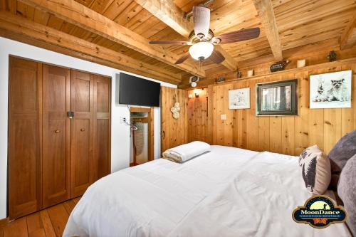 a bedroom with wooden walls and a large white bed at Dogwood Hills in Nashville