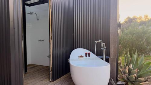 a bath tub in a bathroom with a cactus at Shipwrecked Oasis Ocean Bay Getaway PL in Fingal
