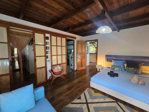 a living room with a bed and a couch at Villa Fareatai in Ataiti