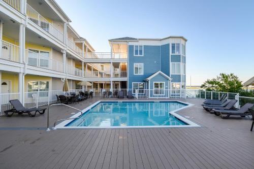 a swimming pool in front of a building at Sunset Bay Villa 110 - Hawks Nest in Chincoteague
