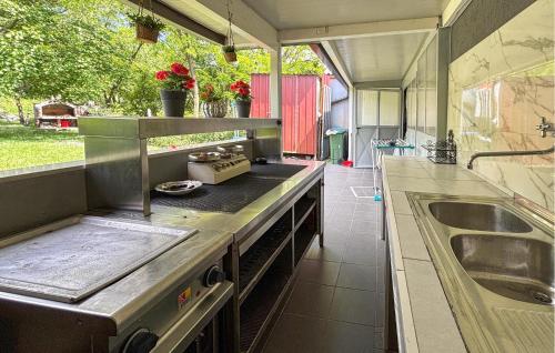 a kitchen with a sink and a counter top at Lovely Home In Podhum With House A Panoramic View in Podhum