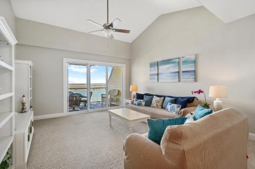 a living room with a couch and a table at Sunset Bay Villa 309 - Changes in Latitude in Chincoteague