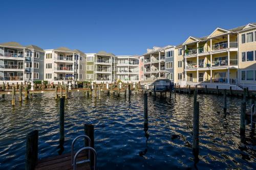 a row of apartment buildings next to a body of water at Sunset Bay Villa 313 - By the Bay in Chincoteague