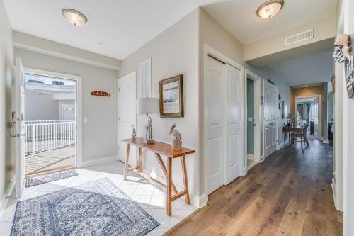a home office with a table and a hallway at Sunset Bay Villa 319 - Bella Vista in Chincoteague