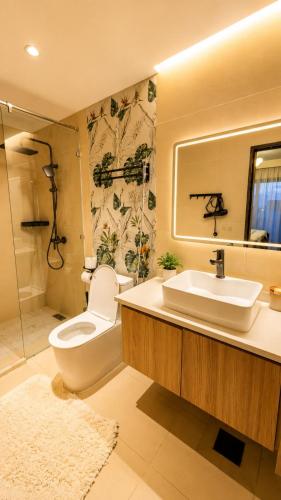 a bathroom with a toilet and a sink and a shower at Desired Atmosphere Safaris in Nairobi