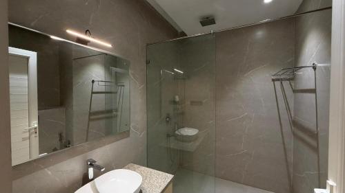 a bathroom with a shower and a toilet and a sink at Hotel skyline by RK in Tinsukia