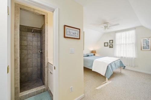 a bedroom with a bed and a walk in shower at The Sweets Spot in Greenbackville