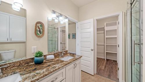 a bathroom with a sink and a mirror at Laguna Sunset by AvantStay in Corpus Christi