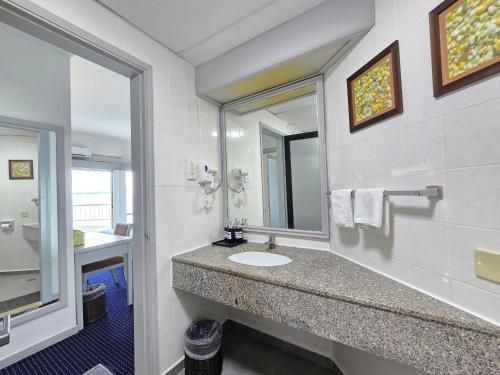 a bathroom with a sink and a mirror at Paradise by the Sea in Penang by Veron at Rainbow Paradise in Tanjung Bungah