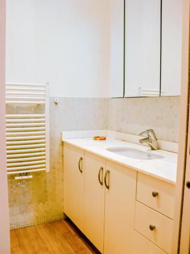 a bathroom with a sink and a mirror at Sanremo Apartments - Orchidea in Sanremo