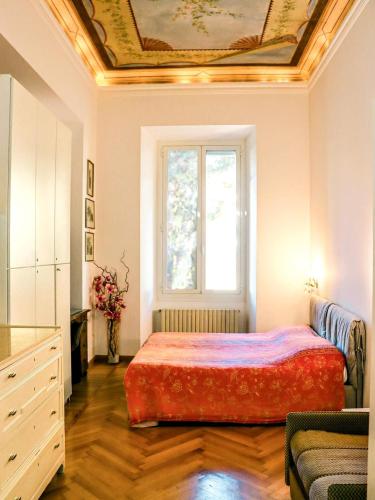 a bedroom with a bed with a painting on the ceiling at Sanremo Apartments - Orchidea in Sanremo