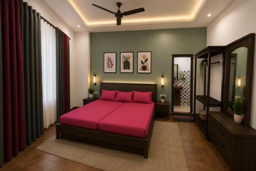 a bedroom with a pink bed and a mirror at Beach Guest House Addalaichenai in Addalachenai