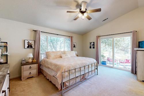 a bedroom with a bed and a ceiling fan at 1 Mi to Lake Tulloch: Home w/ Patio Oasis & Pool in Copper Cove Subdivision