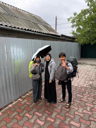 a group of people standing under an umbrella at 51 guest house in Bishkek