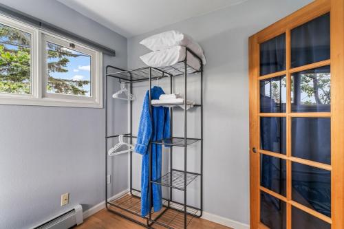 a walk in closet with a black shelving unit at Close To Airport - Shared Space - Fast WI-FI in Anchorage