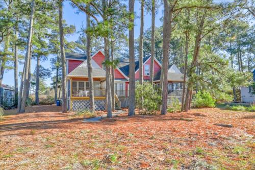 a house in the woods with a yard at Whispering Pines in Black Point Landing