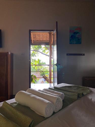 two beds in a room with towels on them at Happiness Boutique Resort El Nido in El Nido