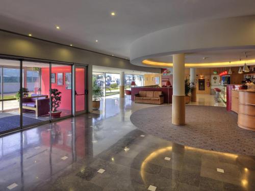 a lobby of a building with a living room at Hotel ibis Porto Sao Joao in Porto