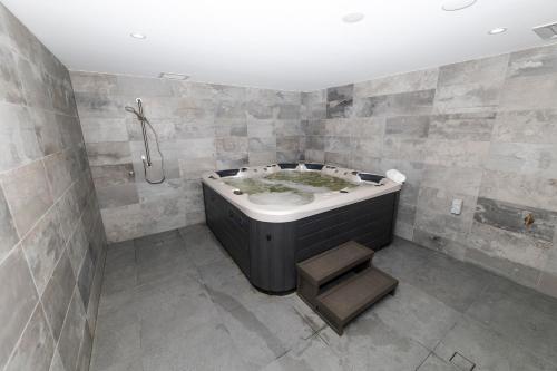 a bathroom with a bath tub and a shower at Carruthers Chalet in Perisher Valley