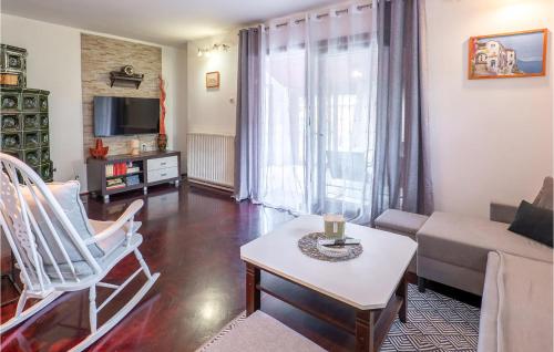 a living room with a couch and a table at Awesome Home In Karlovac in Karlovac