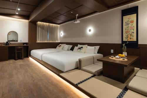 a bedroom with a bed and a desk and a couch at Onjae Stay Seongsu in Seoul
