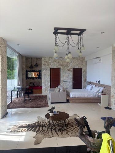 a large living room with a bed and a table at NEW, Modern 1BR with Pool-Kitchen-Workspace-100Mb in Badung