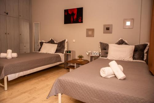 a room with two beds with white towels on them at Stylida Apartment - Ocean Air & Quiet Nights! in Stilís