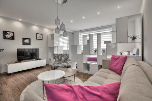 a living room with a couch and a tv at Tuzlaks appartment in Sarajevo