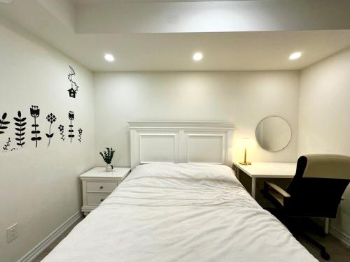 a bedroom with a bed and a desk and a chair at Comfortable 2BR Getaway with Extra Lounge Space in Toronto