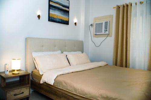 a bedroom with a bed and a air conditioner at Casa Marelle in Lapu Lapu City