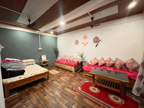 a living room with two beds and a couch at Live in Nature in Darjeeling