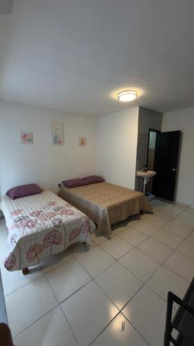 a bedroom with two beds in a room at Hogar ideal in Orizaba