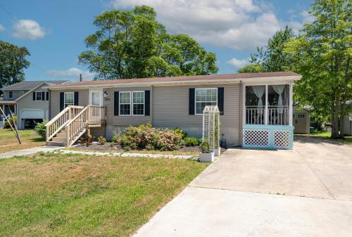 a house with a porch and a driveway at One Peace Cottage in Deep Hole