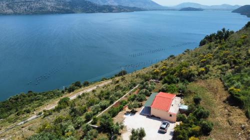 an aerial view of a house on a hill next to a lake at Lakeview Villa Nardi in Ksamil