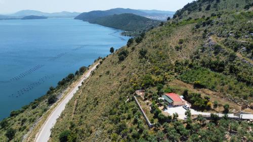 an aerial view of a house on a hill next to the water at Lakeview Villa Nardi in Ksamil