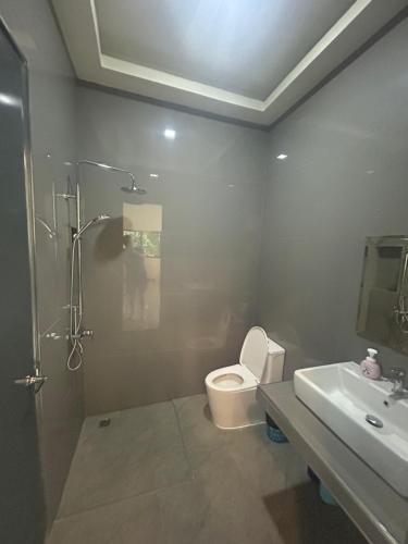 a bathroom with a toilet and a sink and a shower at Private Pool Villa Huay Yai in Ban Bung