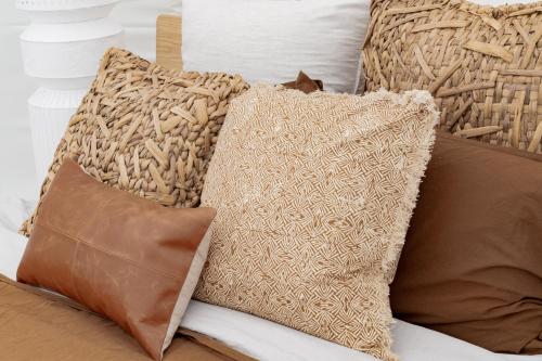 a pile of pillows sitting on a bed at Captain Moonlite Bubbletent at Mirumiru in Tenterfield
