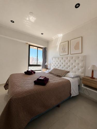 a bedroom with a large bed and a window at Suite Premium Vista Panorámica in Santa Teresita