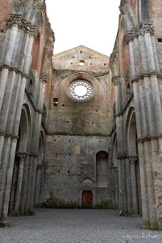 an old brick building with a window in it at La Palazzina in Chiusdino